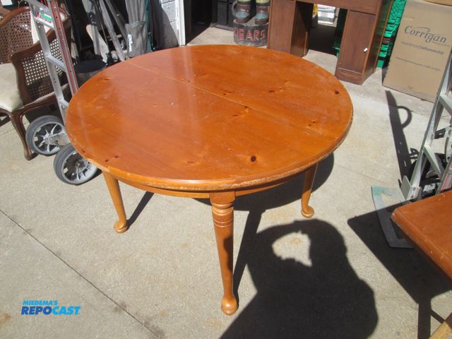 Lot 2-56969 - 44" round knotty pine dining table 30" high 20" in-set leaf, (4) chairs w/ carvings on the back. (4)...