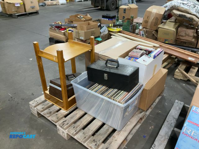 Lot 2-18937 - Skid lot of miscellaneous items including various records, VHS tapes, wooden side table, and more