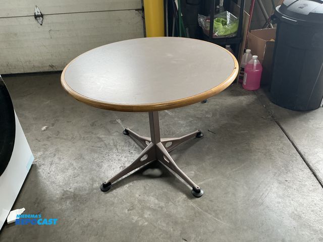 Lot 2-69794 - Herman Miller 36" round  table, color HT (gray) formica with ash bullnose edging. relay glide base.