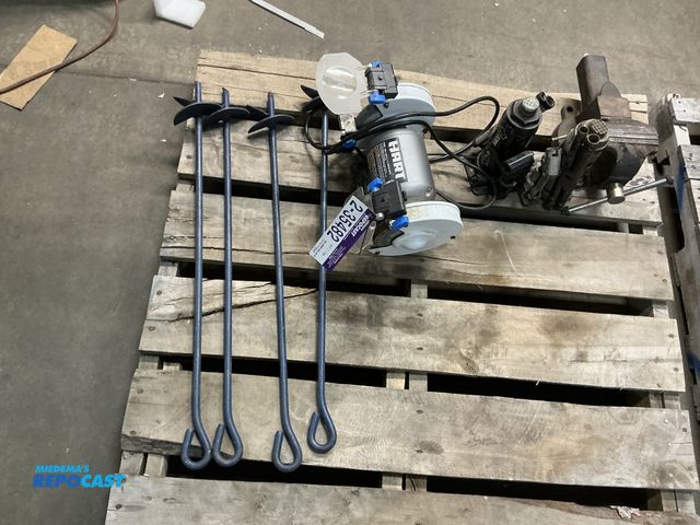 Lot 2-35482 - hart 2 wheel grinder and 4 house tie down stakes that are about 2' tall. used for holding canopies t...