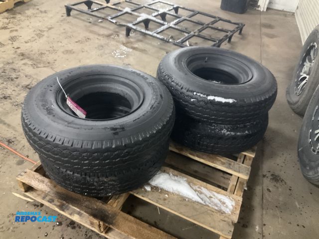 Lot 2-23811 - (4) 8-14.5 tires on steel mobile home style wheels, one tire is flat/off the bead, used