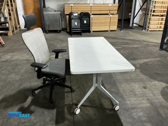 Lot 2-55172 - Lot of (1) rolling office table 60“ x 30“ rubberized edging also includes rolling office chair, padd...