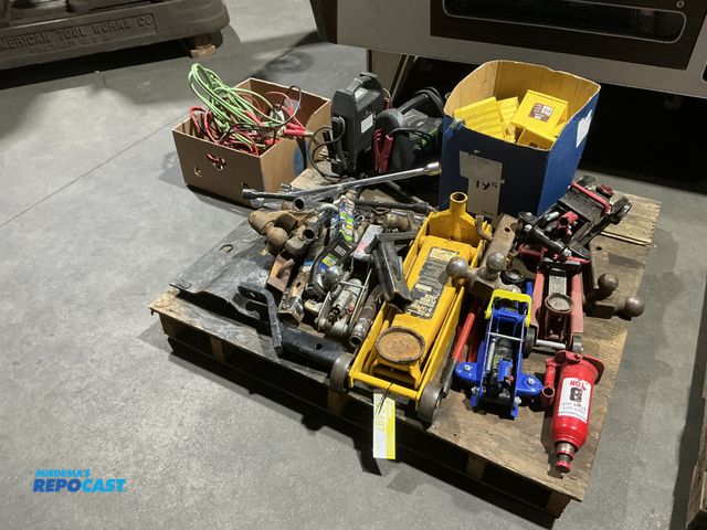 Lot 2-55497 - Large skid lot of assorted garage items. Including multiple floor jacks, jumper cables, hitches, tow...
