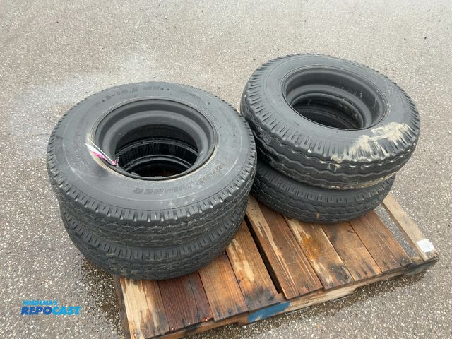 Lot 2-22438 - (4) 8-14.5 tires on steel mobile home style wheels, used, one is flat