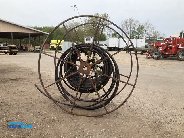 Lot 2-43279 - Metal spool with 1-1/4” poly pipe on it, unknown length, spool is approx 81”T and 37-1/2”W