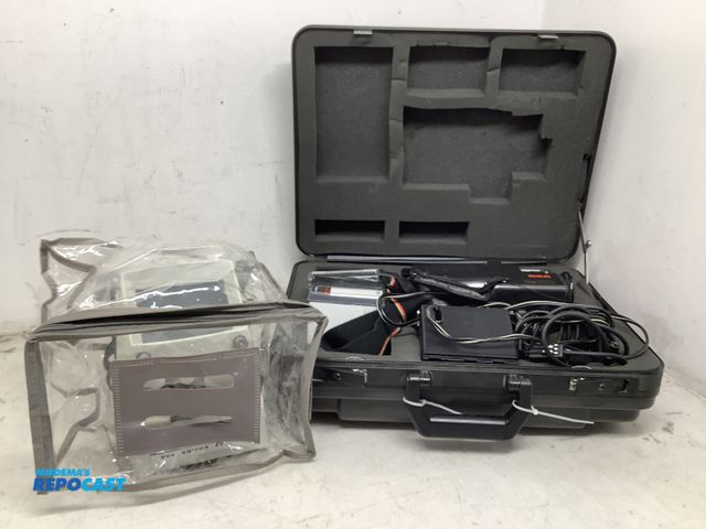 Lot 2-35500 - Lot of (2) a vintage RCA VHS camcorder kit in hard carrying case model CPR100, and a Honeywell Elmo ...