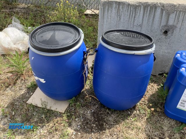 Lot 2-15587 - lot of 2 25 gallon blue plastic barrels with removable lids and locking rings, clean inside, contain...