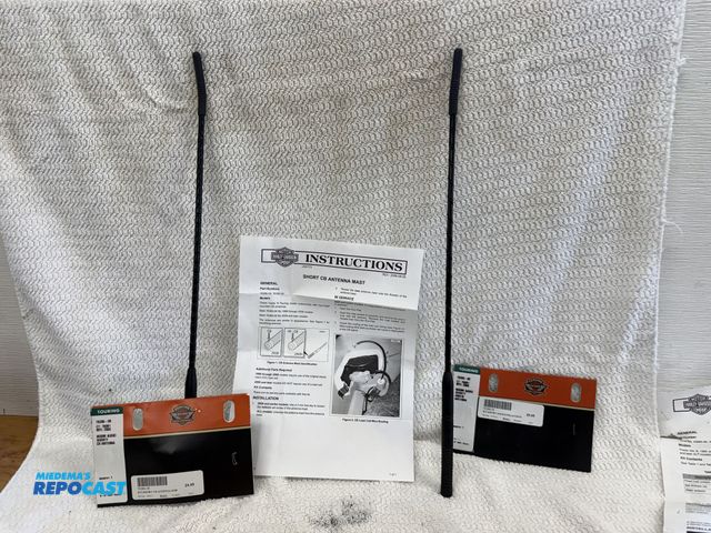 Lot 2-74178 - Lot of (2) Harley Davidson Head Bolt Covers. 1 is a 76386-08 Boom! Audio Shorty CB Antenna, and 1 is...