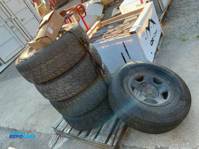 Lot 2-96789 - Lot of 5 tires - 4 have aluminum rims with caps rims, 4- cooper discoverer 265/75R16, 1- Bridgestone...