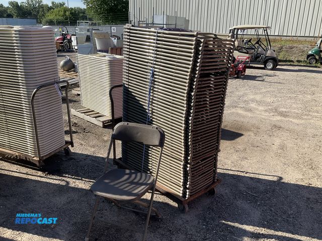 Lot 2-13924 - Chairs Stack of plastic and metal foldable chairs green on metal rolling cart