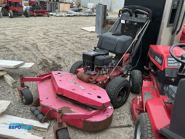 Lot 2-40542 - Toro 286707 Self-Propelled Lawn Mower Push Mower (1) old red toro lawn mower cuts from front mostly ...
