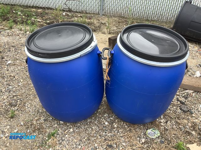 Lot 2-99962 - (2) 25gal. blue plastic barrels w/ removable lids and locking rings - clean inside, contained a food...