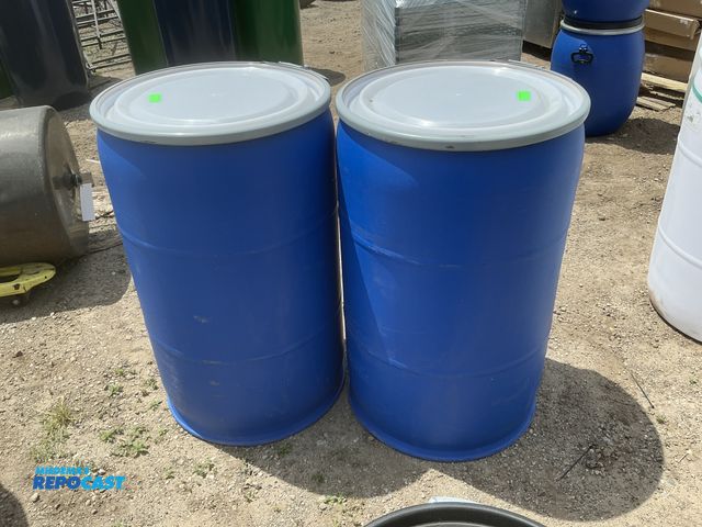 Lot 2-64039 - lot of 2 55 gallon blue plastic barrels with removable lids and locking rings, clean inside, contain...