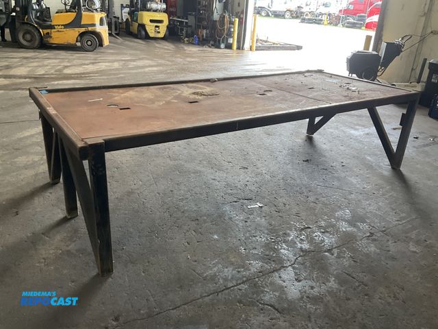 Lot 2-34929 - Steel work bench / welding table 127”L x 50.5”W x 32”T overall, two piece steel top is not not attac...