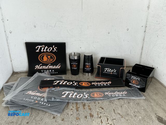 Lot 2-96768 - Lot of Tito’s bar ware including (6) bar mats, (2) napkin holders, and (2) shakers