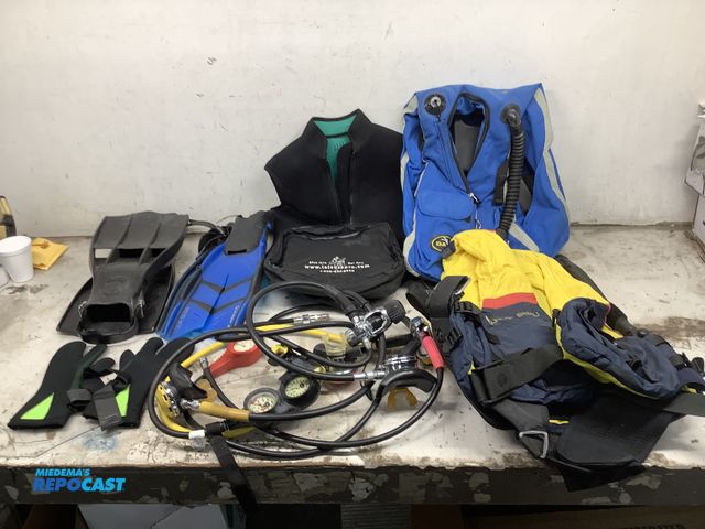 Lot 2-75567 - Lot of various scuba gear including water gloves, oxygen guages, scuba diving fins, a bag, a Bora-Bo...