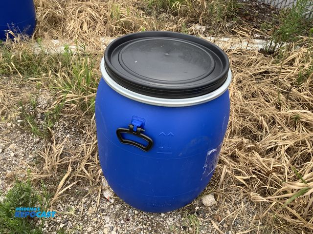 Lot 2-18415 - 25 gallon blue plastic barrel with removable lid and locking rings. Clean inside. Contained food pro...