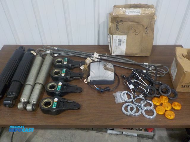 Lot 2-11527 - Lot of new/old stock truck replacement parts, Shocks, slack adjusters, lights, heated spot mirror, e...