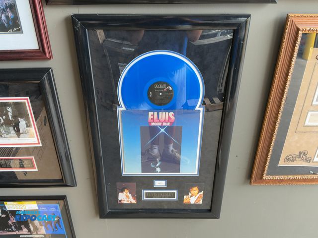 Lot 2-53330 - Framed Elvis Presley “Moody Blue” Record, Autograph, (2) Pictures, and Plaque, 23” x 37”