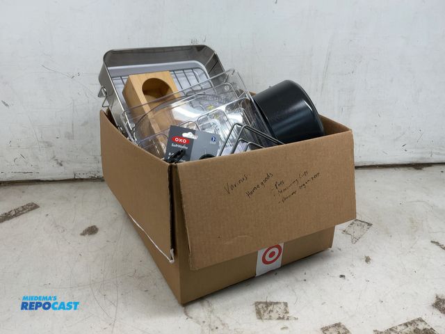 Lot 2-96709 - Box of various home goods including pots, measuring cups, drawer organizers, and more