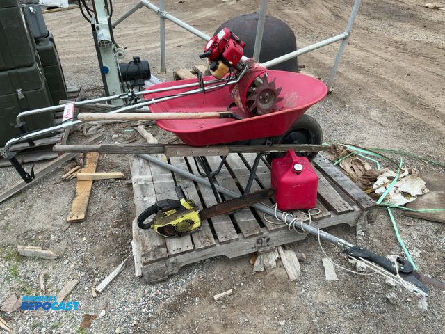 Lot 2-67789 - Lot of assorted lawn care equipment. Includes a wheel barrel, a chainsaw, a pole saw, a tiller/ cult...