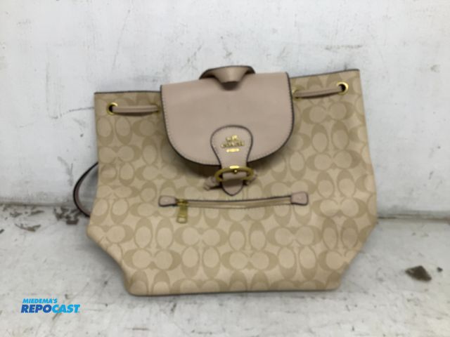 Lot 2-74020 - New Beige and tan Coach drawstring backpack, signature coated canvas and a front zipper pocket
