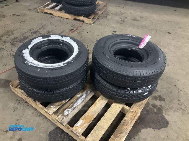 Lot 2-23812 - (4) 8-14.5 tires on steel mobile home style wheels, one tire is flat/off the bead, used