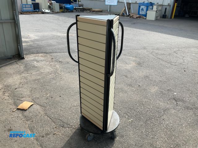 Lot 2-64245 - Portable beige slat wall tower displayed fixture with a metal frame and rolling casters