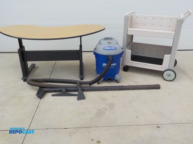 Lot 2-34195 - ShopVac. Reception table with locking castors and adjustable height. Rubbermade stocking cart.