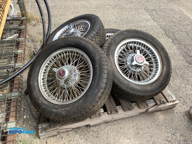 Lot 2-96104 - Lot of (4) Pirelli P6 tires P215/60 R15 93 H with rims and ford “spinners”