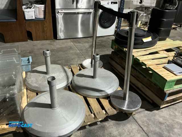 Lot 2-55185 - (3) heavy duty, umbrella bases, and (2) retractable belt stanchion stands.  (RSSC)