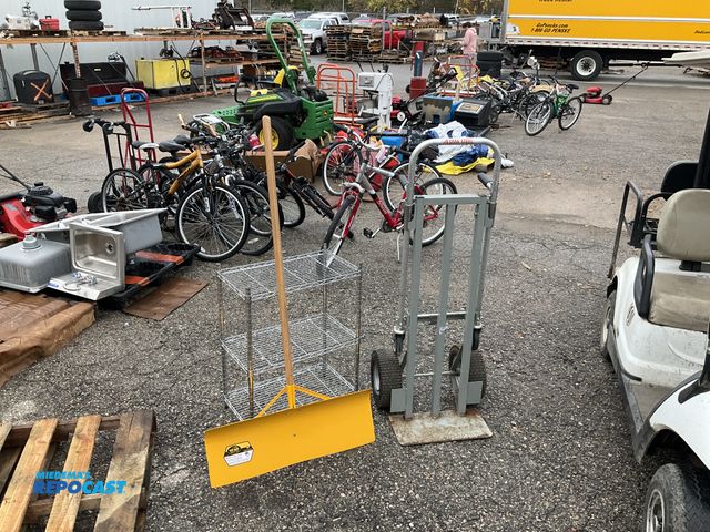 Lot 2-69767 - Lot of garage keepers, including yellow snow shovel, small metal shelf, and dolly.