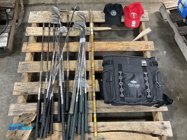 Lot 2-24567 - Lot of golf clubs, 2 hats, a bag, and a spear.
