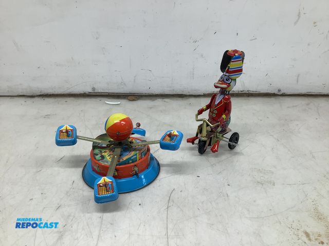 Lot 2-64375 - 2 wind up tin toys, wind up duck on a trip cycle with spinner hat and wheels that move and a win dup...