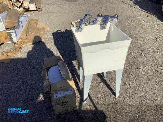 Lot 2-35707 - E. L. Mustee Utilatub utility sink with metal legs, American Standard Cadet Pro toilet back, and (2)...