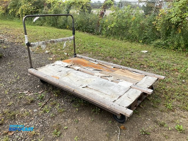 Lot 2-41202 - Metal transport cart with handle 80”L x 54”W, steel deck has three 2x4s screwed into it, used