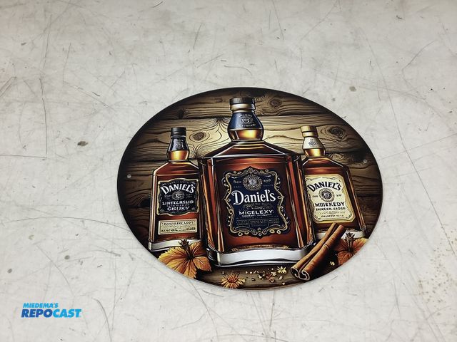 Lot 2-75384 - Daniel’s circular metal tin sign approx. 8”