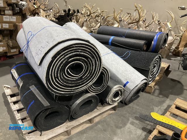 Lot 2-18181 - 2 skids of rolls of black mats/rugs/flooring amount unknown