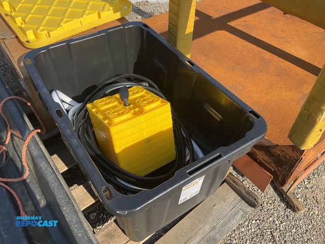 Lot 2-96844 - Box of camping and RV supplies a yellow camco fasten RV leveling blocks, some wheel stop ramps, and ...
