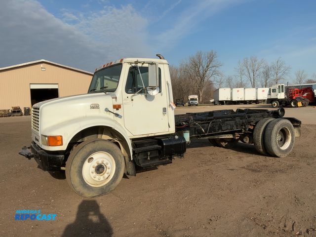 Lot 2-43052 - 1997 International 4900 Hook Lift Roll Off Truck