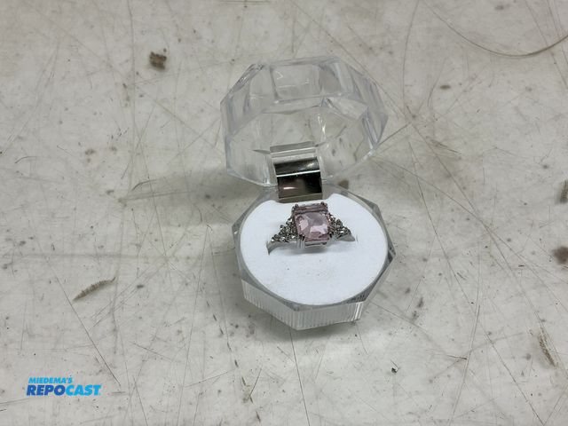 Lot 2-10049 - Silver emerald cut rose ring with smaller silver stones size 11 case included