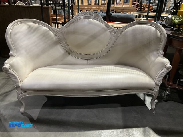 Lot 2-55026 - Cream Victorian Style Settee Cream colored Victorian style settee with ornate wood carving on back, ...