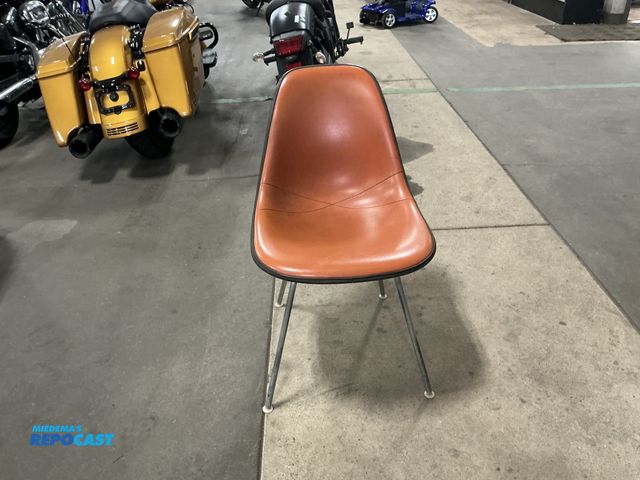 Lot 2-69796 - Herman Miller 1980 orange padded chair with black fiberglass back.