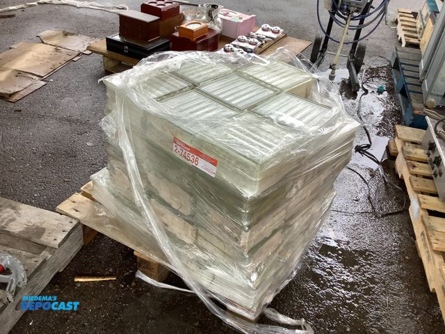 Lot 2-74536 - Stack of glass bricks, 7 3/4“ x 7 3/4” x 3 3/4”. About 43 blocks.