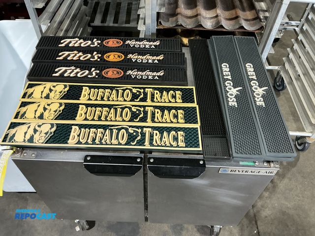 Lot 2-55180 - 18 Promotional rubber spill mats for bar. Tops includes Grey, goose, Tito‘s handmade vodka, and buff...