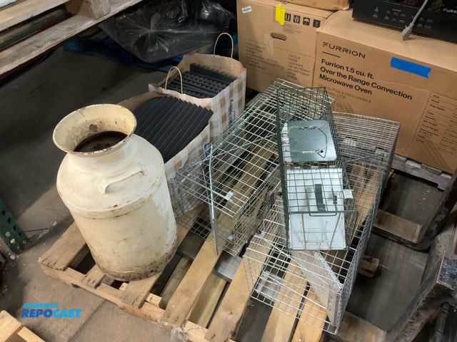 Lot 2-37045 - Skid lot of of miscellaneous items including 3 live traps, vintage milk jug, and foam sound muffler ...