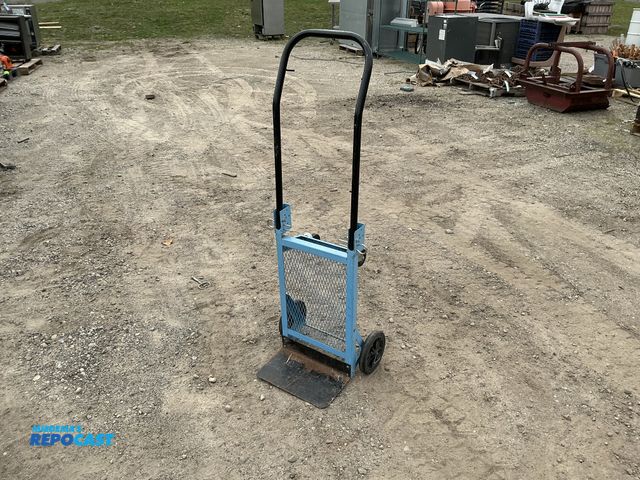 Lot 2-62945 - Blue dolly with mesh metal safety sheet and wheels.