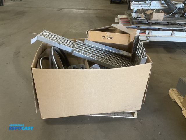 Lot 2-11693 - Box of misc truck parts including hoses, lugnut covers, aluminum step treads and some wiring
