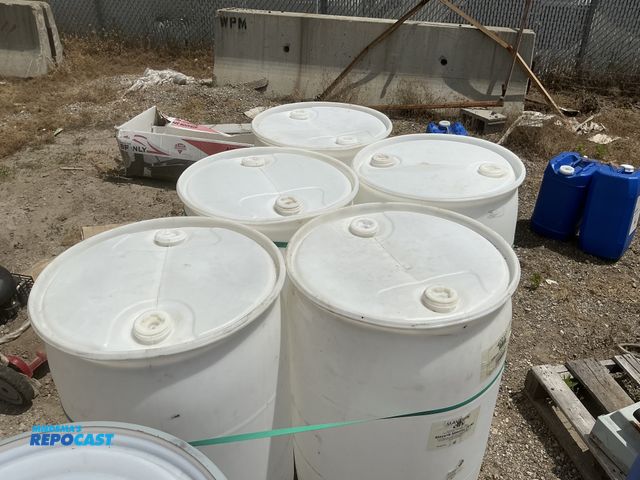 Lot 2-64041 - lot of 5 55 gallon white plastic barrels with 2 removable bungs, contained mineral oil