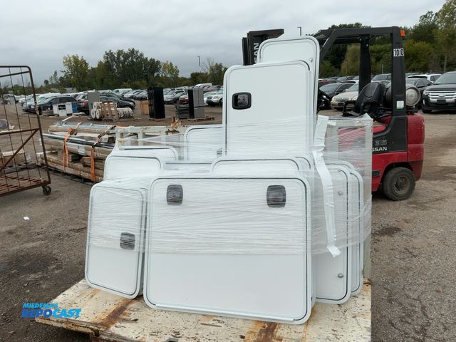 Lot 2-33997 - Skid lot of various sizes of RV cargo doors, all white